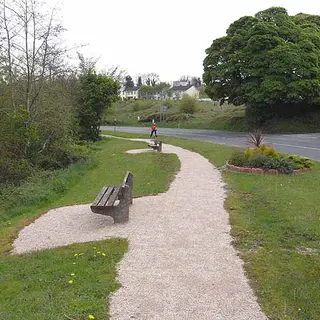 A gravel walk and a bench beside the road on the Killeshandra loop