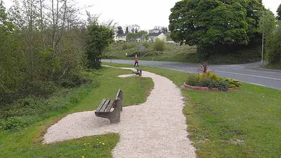 A gravel walk and a bench beside the road on the Killeshandra loop