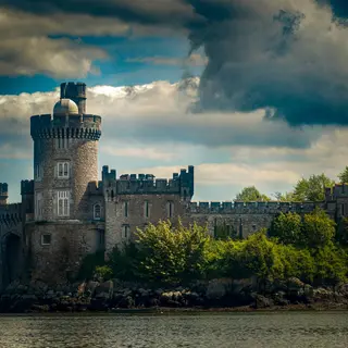 Blackrock Castle on the bank of the River Lee under a dark sky
