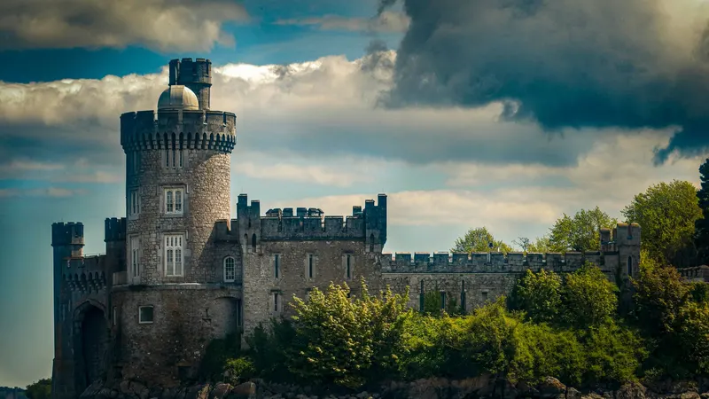 Blackrock Castle on the bank of the River Lee under a dark sky