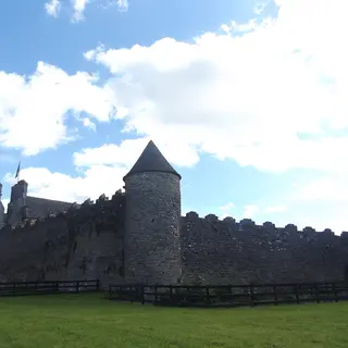 The round tower and curtain wall of Parke's Castle above Lough Gill