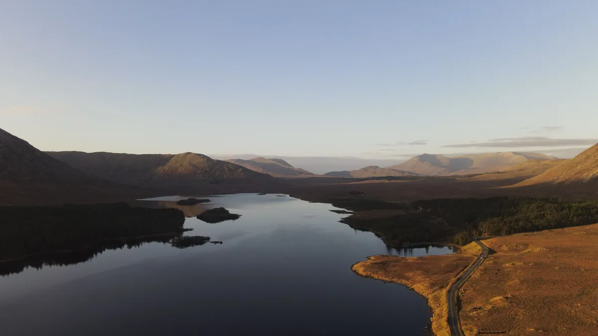 Lough Inagh holding the shadow of the mountains at sunset in Connemara