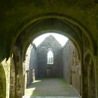 The vaulted stone ceiling and east window inside Kilcooley Abbey