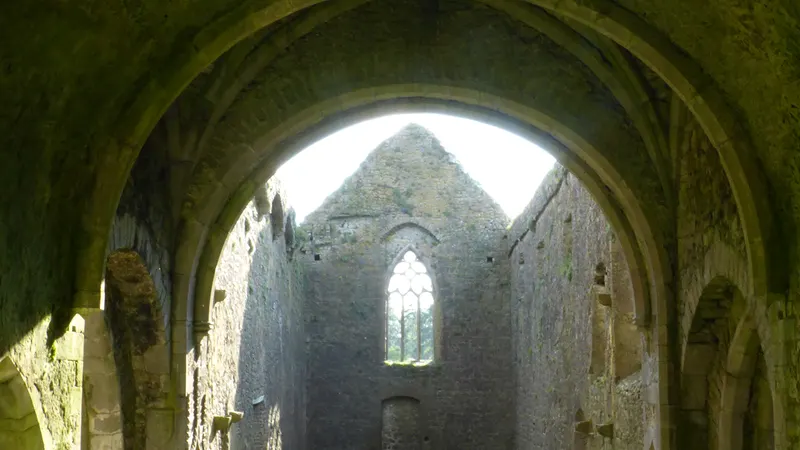 The vaulted stone ceiling and east window inside Kilcooley Abbey