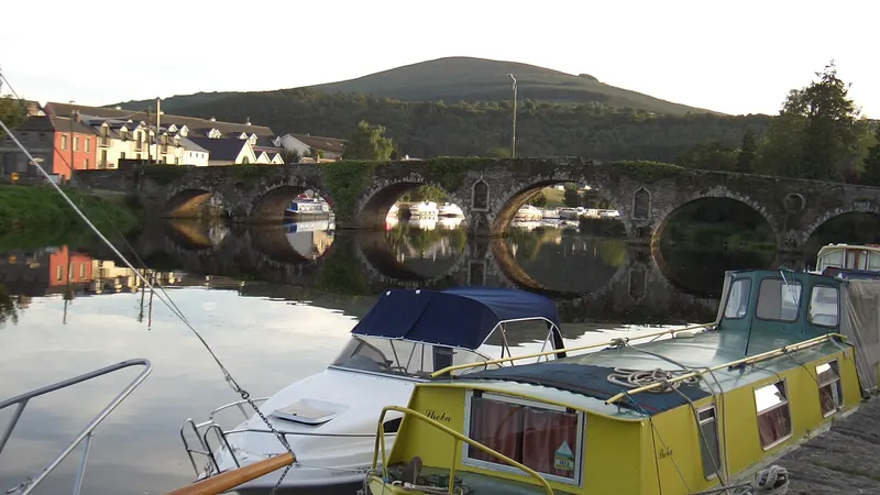Barges moored on the Barrow below the arched stone bridge at Graiguenamanagh