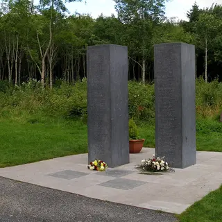 Two tall granite slabs standing on a paved square in Donadea Forest Park