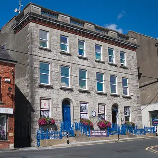 The brick and stone front of Monaghan County Museum on the street