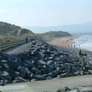 The boardwalk and stone sea defence above the surf at Strandhill