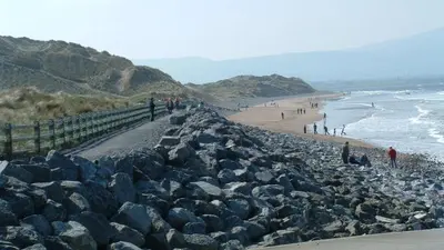 The boardwalk and stone sea defence above the surf at Strandhill