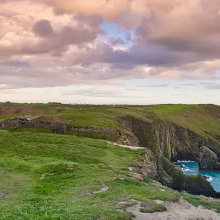 Cliffs and a stone ruin on a headland near Kinsale at sunset