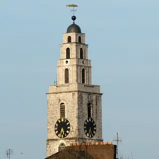 The clock tower and weathervane of Shandon above the rooftops of Cork city