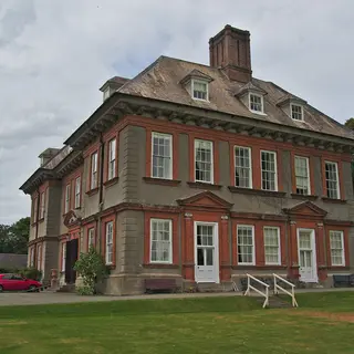 The red brick front of Beaulieu House across its lawn