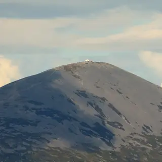 The bare grey cone of Croagh Patrick with the white chapel on its summit