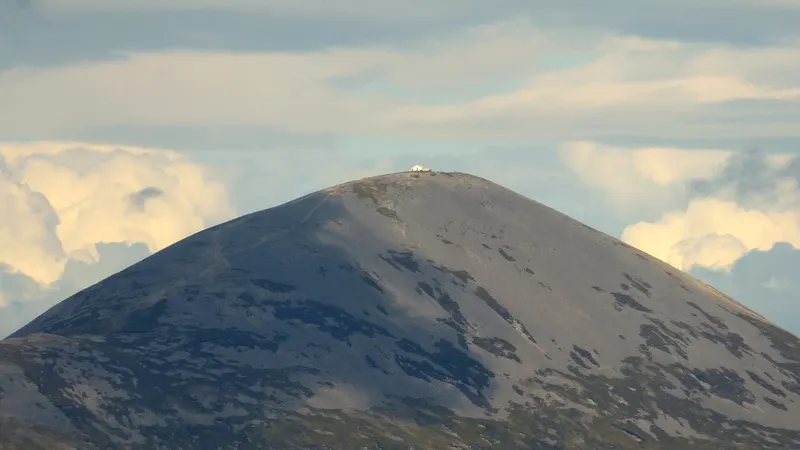 The bare grey cone of Croagh Patrick with the white chapel on its summit