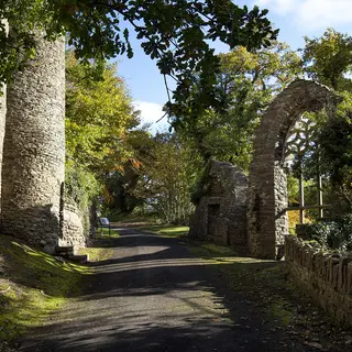 The castle folly and stone arch on the walk through Heywood Gardens