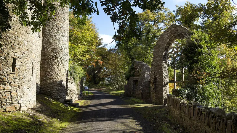 The castle folly and stone arch on the walk through Heywood Gardens