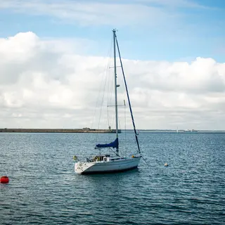 A sailing boat on the water inside Dun Laoghaire harbour
