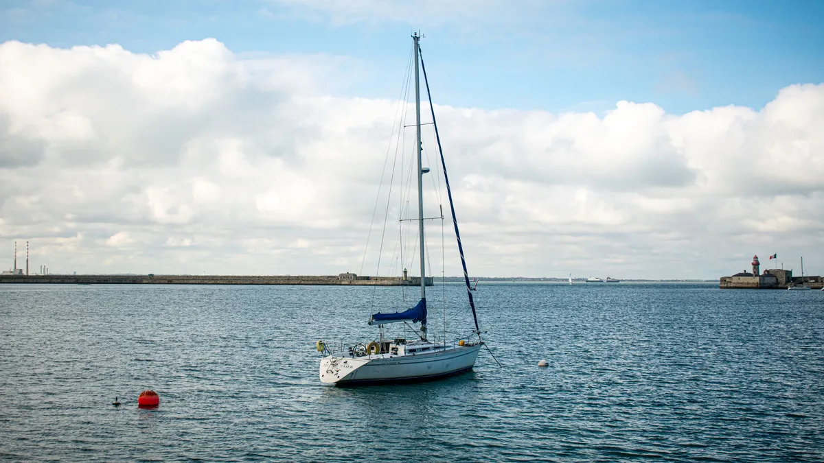 A sailing boat on the water inside Dun Laoghaire harbour