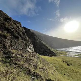 Sun over the cliffs and the long strand on Achill Island