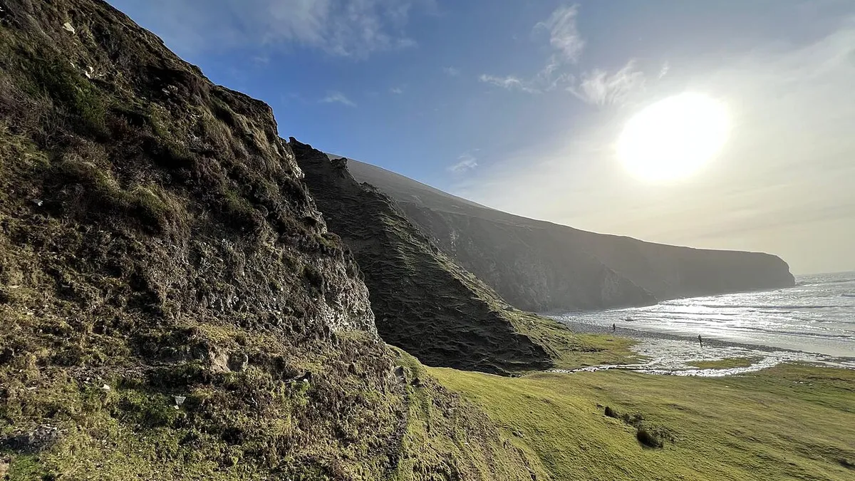Sun over the cliffs and the long strand on Achill Island