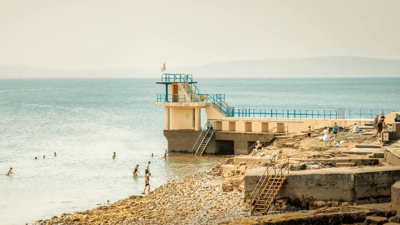People on the diving board at the end of Salthill promenade