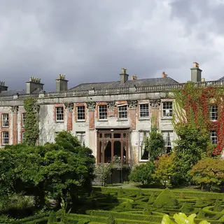 The long front of Bantry House behind its box hedge garden
