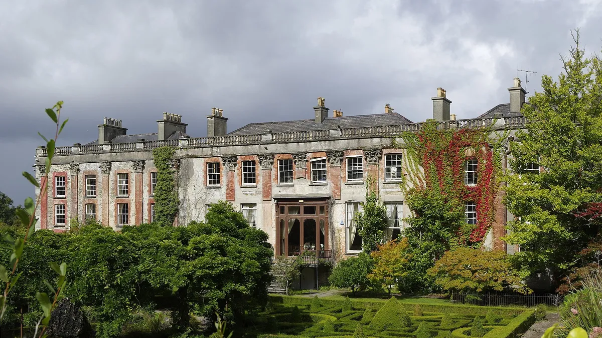 The long front of Bantry House behind its box hedge garden