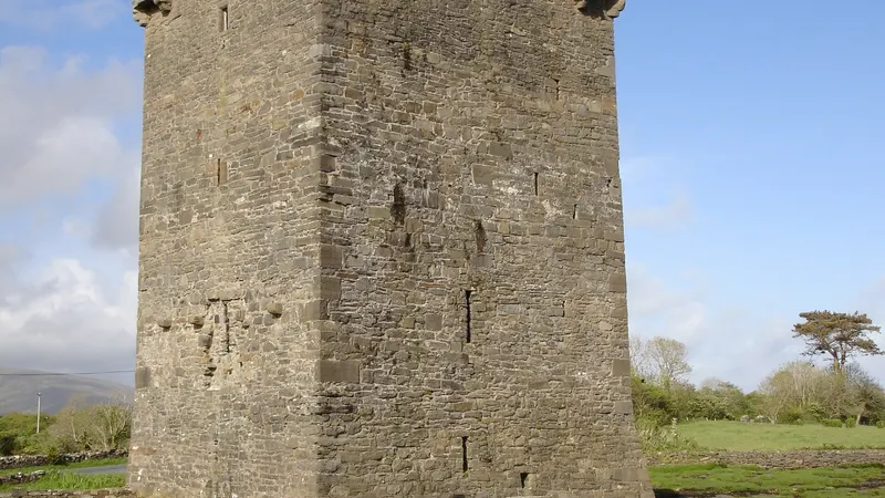 The square tower of Rockfleet Castle standing on the shore of Clew Bay