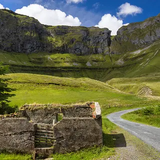 The road running into the cliffs and green floor of the Gleniff Horseshoe