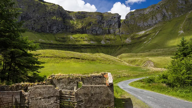 The road running into the cliffs and green floor of the Gleniff Horseshoe