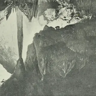 A tall stone column formation inside Mitchelstown Cave, County Tipperary