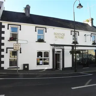 The white painted Bridge House on the street corner in Drumshanbo