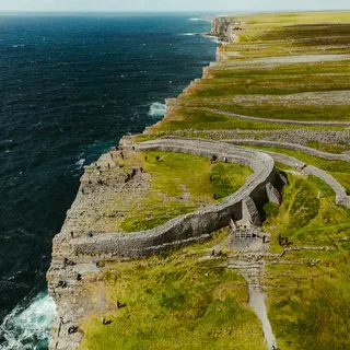 The stone ramparts of Dun Aonghasa on the cliff edge, from the air