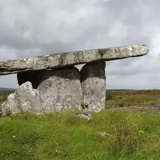 The capstone of Poulnabrone Portal Tomb resting on its uprights out on the Burren limestone