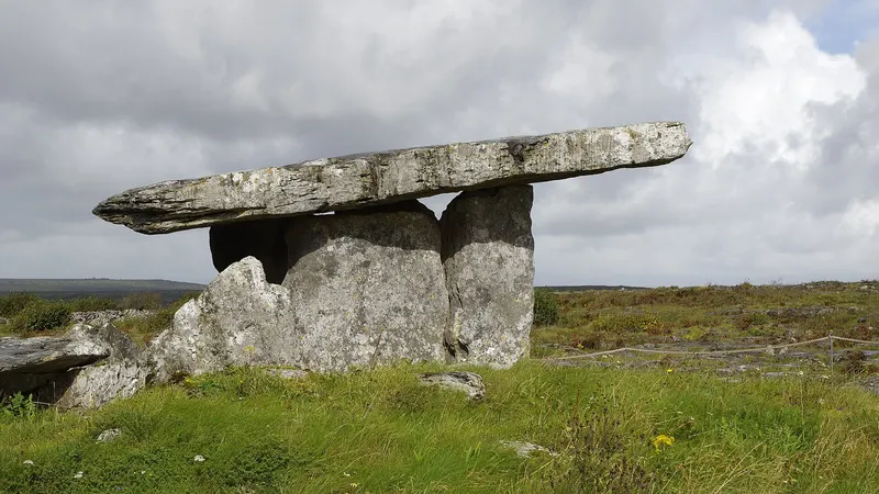 The capstone of Poulnabrone Portal Tomb resting on its uprights out on the Burren limestone