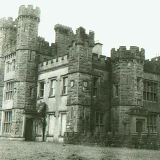 The castellated front of Castle Saunderson in an old black and white photograph