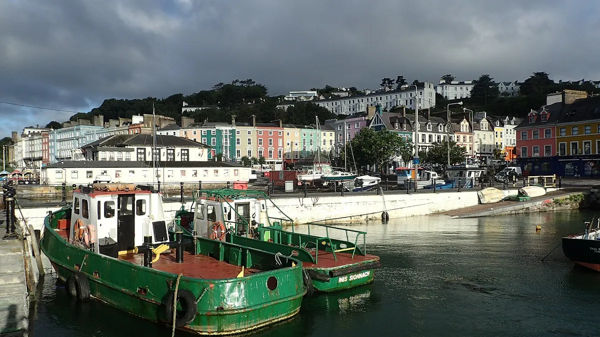 Fishing boats in the harbour at Cobh with the coloured terraces above