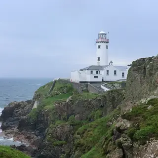 Fanad Head Lighthouse on its cliff above the sea, County Donegal
