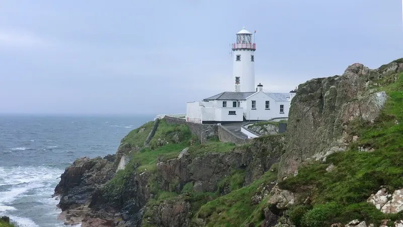 Fanad Head Lighthouse on its cliff above the sea, County Donegal