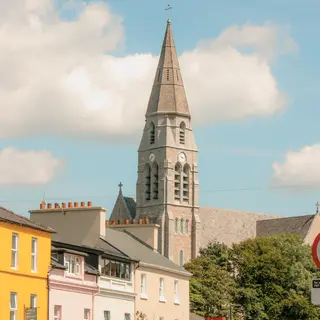 Coloured buildings and the church spire in the middle of Clifden