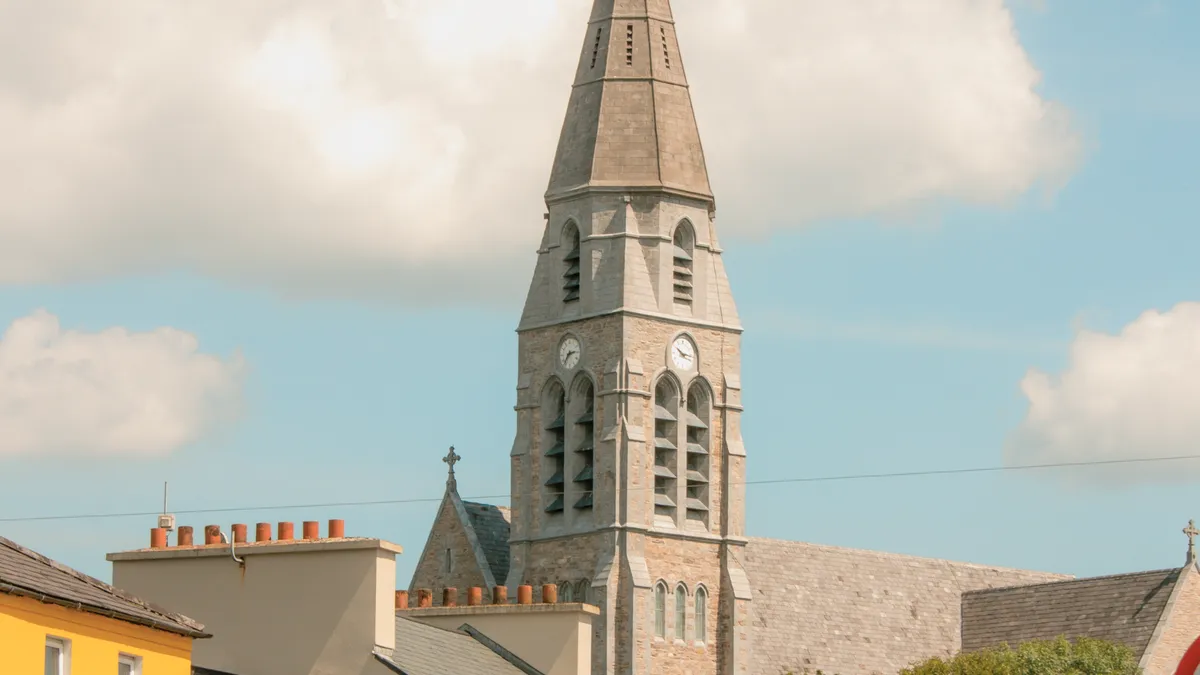 Coloured buildings and the church spire in the middle of Clifden