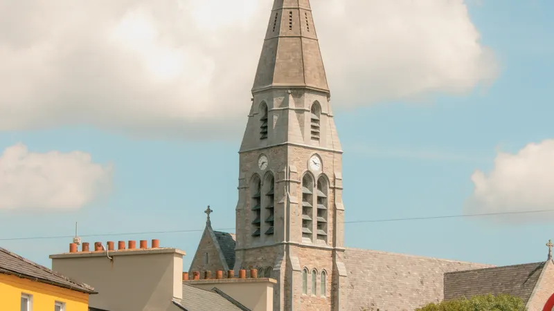 Coloured buildings and the church spire in the middle of Clifden