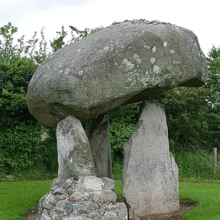 The rounded capstone of Proleek Dolmen balanced on its three uprights
