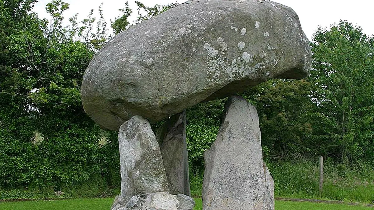 The rounded capstone of Proleek Dolmen balanced on its three uprights