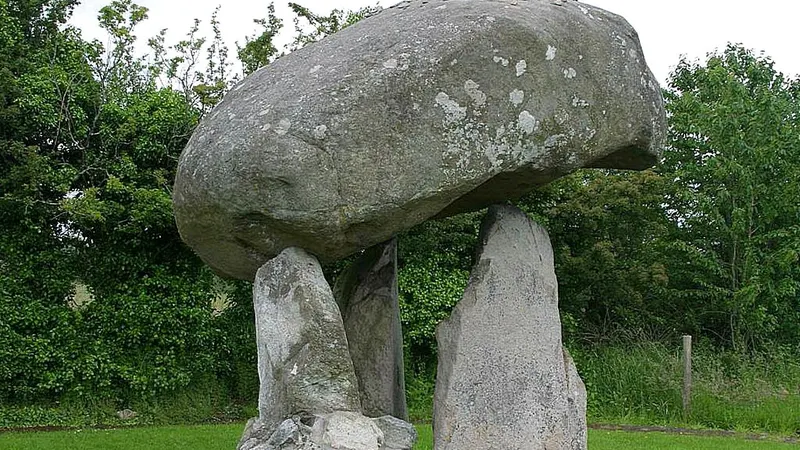 The rounded capstone of Proleek Dolmen balanced on its three uprights