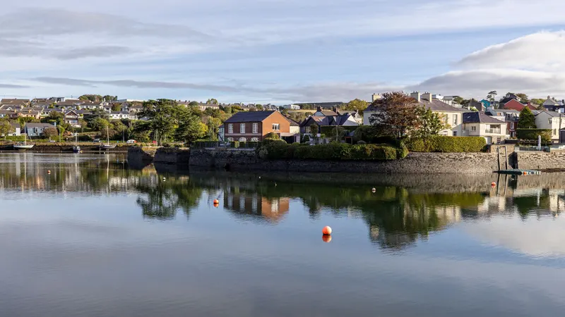 Waterfront houses reflected in the calm water at Kinsale