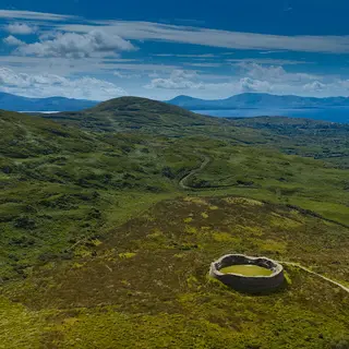 The circular wall of Staigue Fort sitting in the hill above the valley