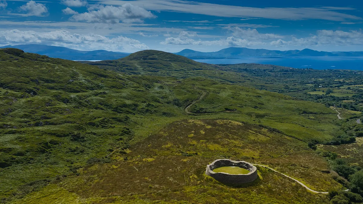 The circular wall of Staigue Fort sitting in the hill above the valley