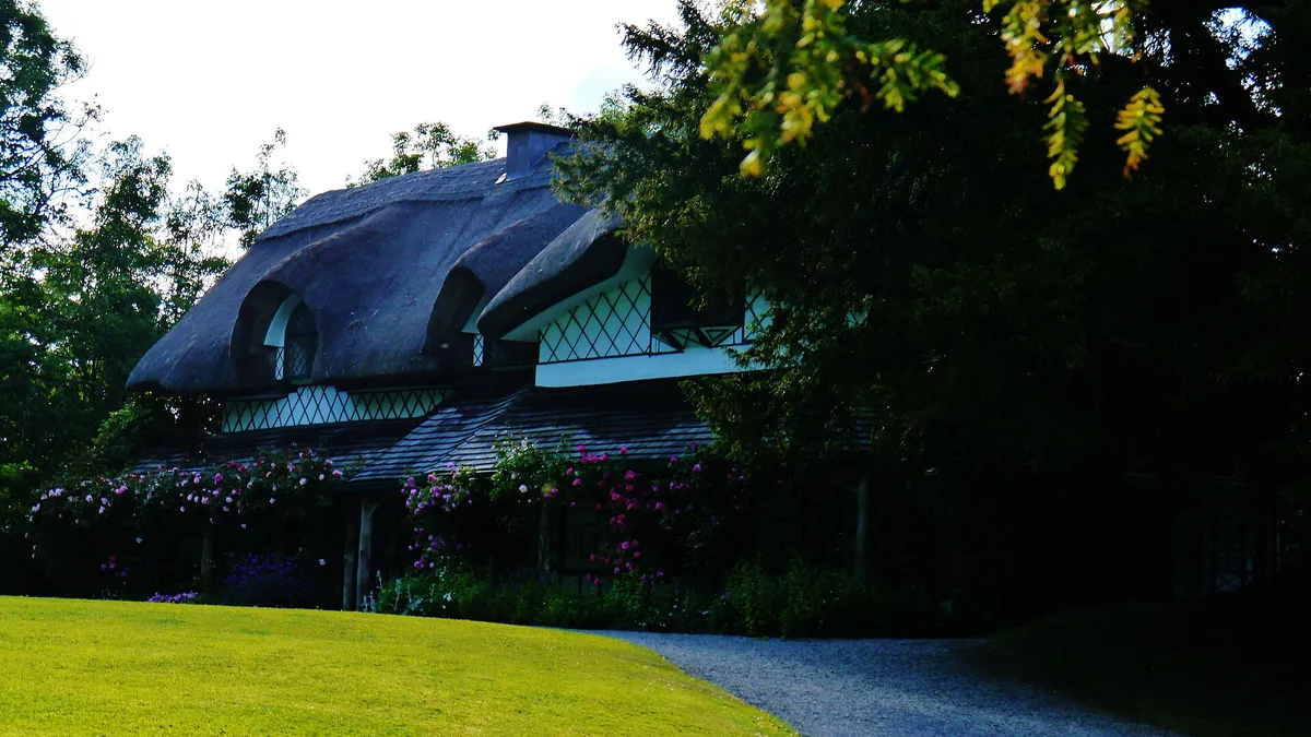 The curved thatched roof and veranda of the Swiss Cottage at Cahir
