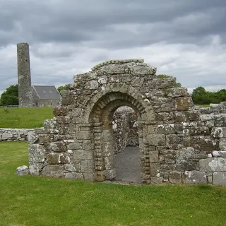 The Romanesque doorway of St Brigid's church on Holy Island, with the round tower behind